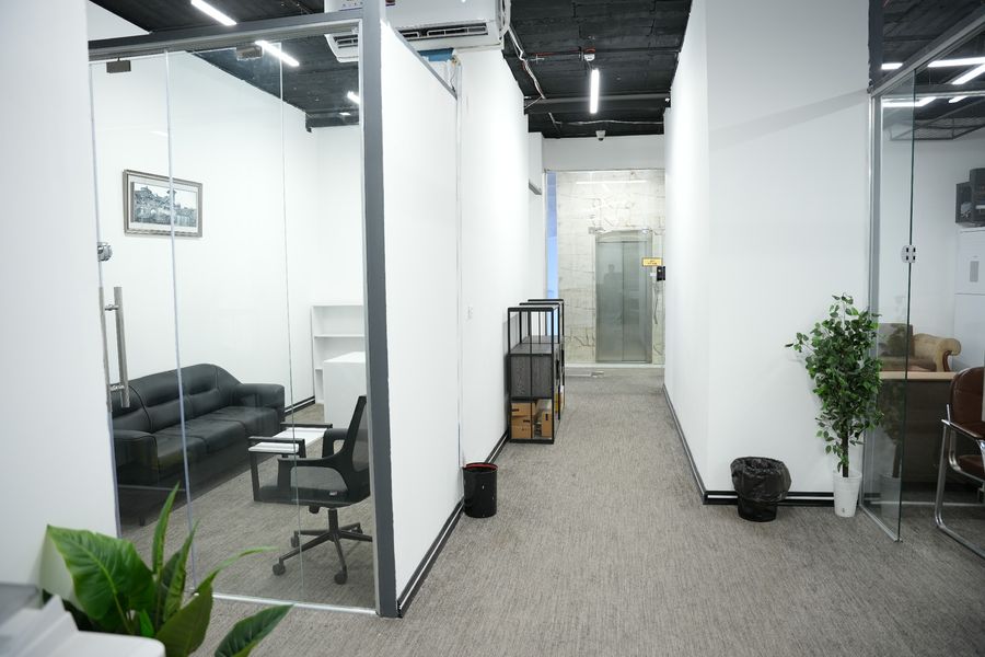 Furnished private office with glass partitions and lounge seating inside Business Hub, Basra