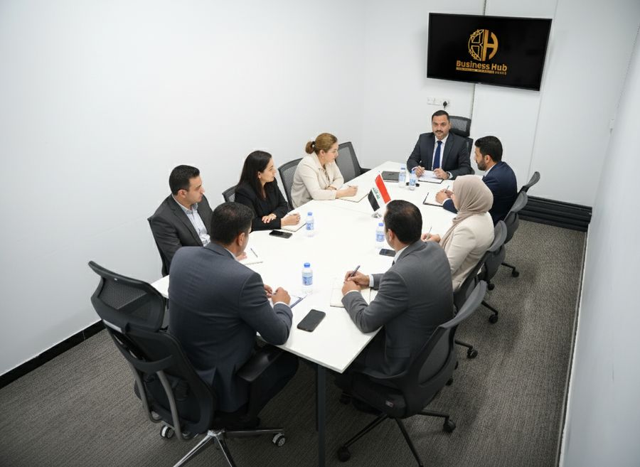 Team meeting around a conference table in a Business Hub meeting room